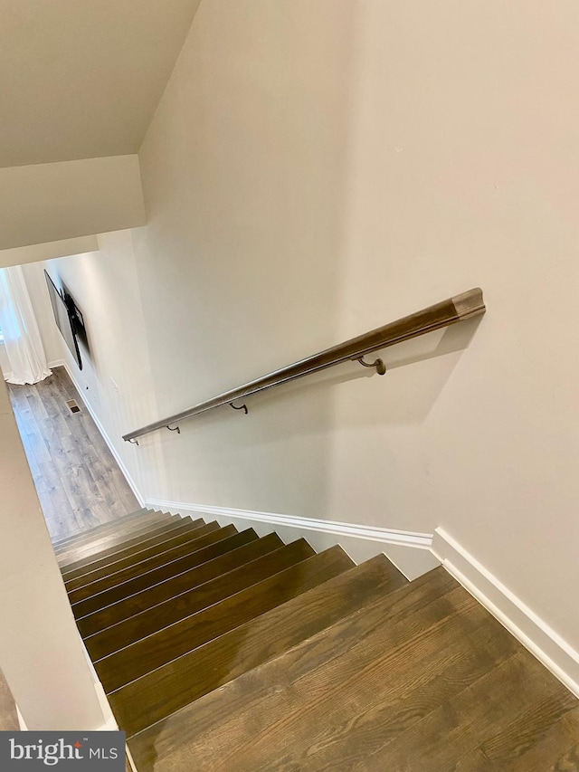 stairs with hardwood / wood-style flooring