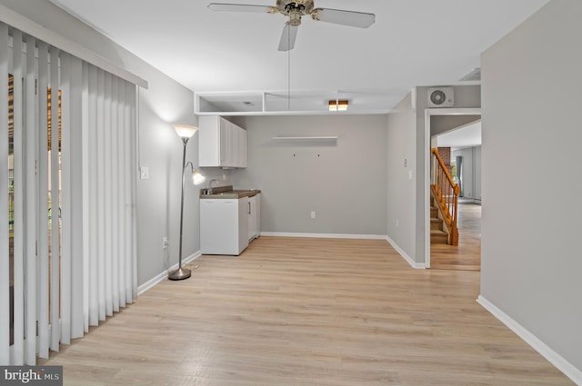 interior space with light wood-type flooring, sink, and ceiling fan