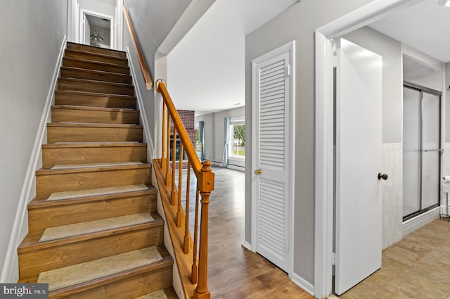 stairs with hardwood / wood-style floors