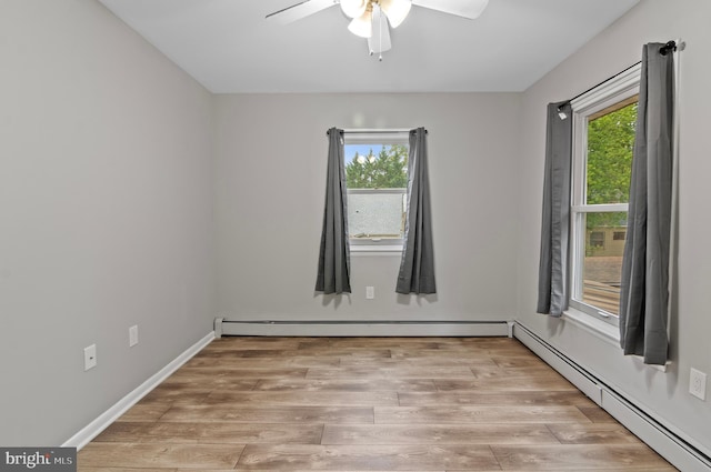 spare room with ceiling fan, light hardwood / wood-style flooring, a baseboard heating unit, and a healthy amount of sunlight