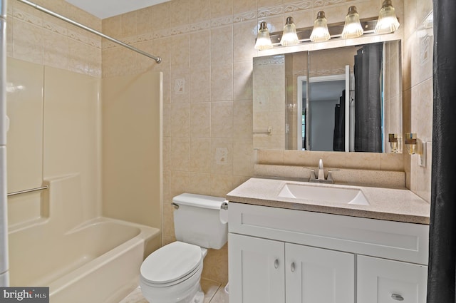 full bathroom with tile walls, vanity, shower / bathtub combination, toilet, and tile patterned floors