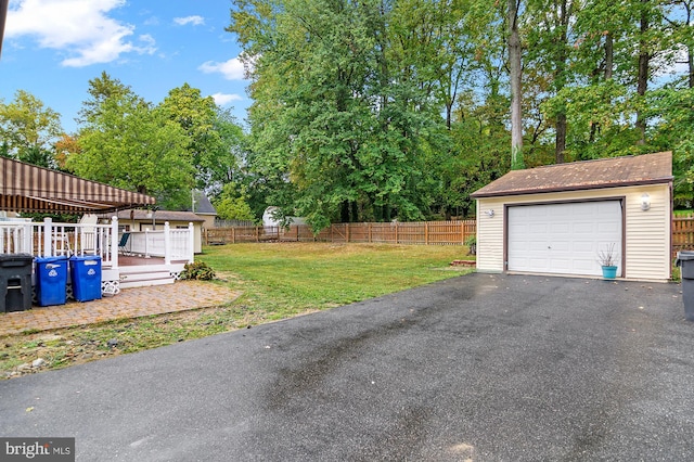 exterior space with a deck, an outdoor structure, and a garage