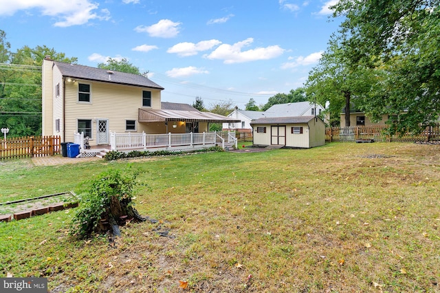 view of yard featuring a storage shed and a wooden deck