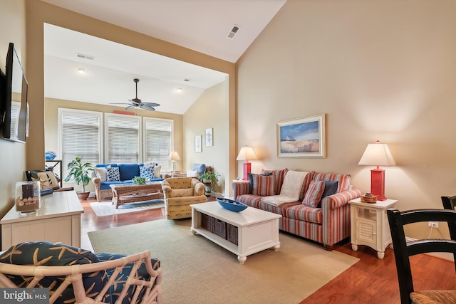 living room with wood-type flooring, high vaulted ceiling, and ceiling fan