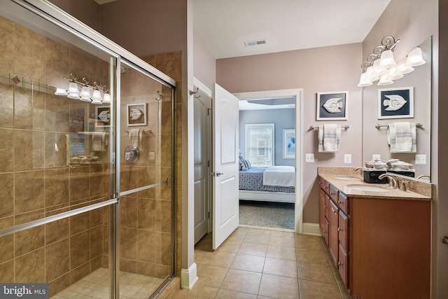 bathroom featuring vanity, tile patterned flooring, and an enclosed shower