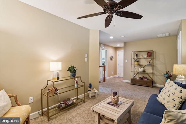 living room featuring carpet floors and ceiling fan