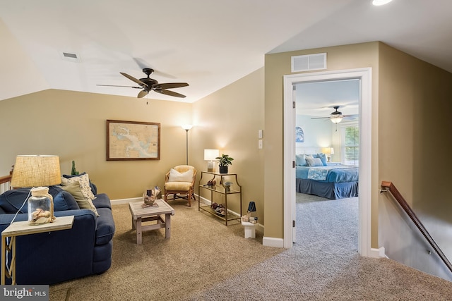 interior space with ceiling fan, carpet flooring, and vaulted ceiling