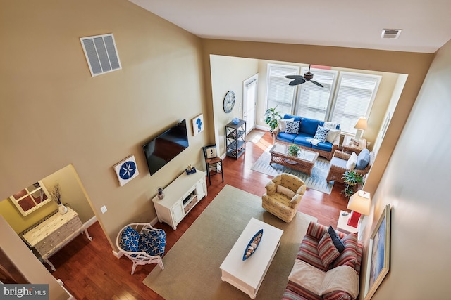 living room featuring wood-type flooring, vaulted ceiling, and ceiling fan