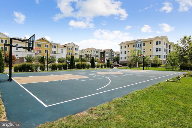 view of basketball court with a yard