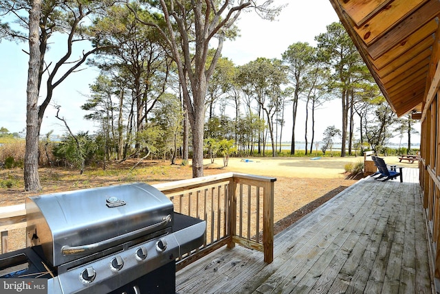 wooden terrace with a grill