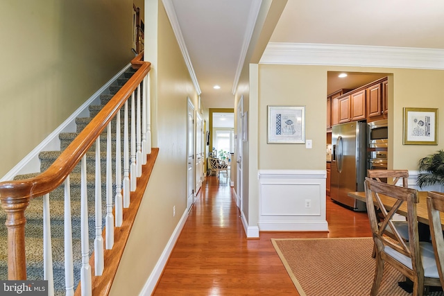 interior space with ornamental molding and hardwood / wood-style floors