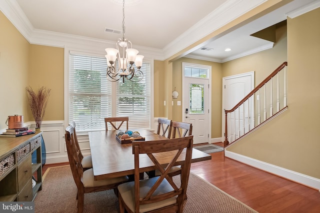 dining room featuring ornamental molding, a notable chandelier, and hardwood / wood-style floors