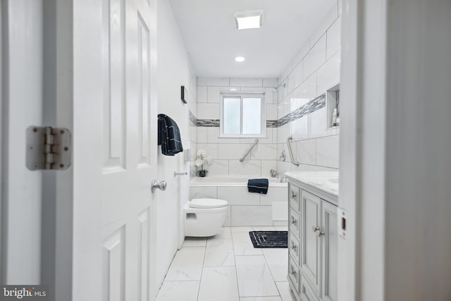 full bathroom with vanity, tiled shower / bath combo, and toilet