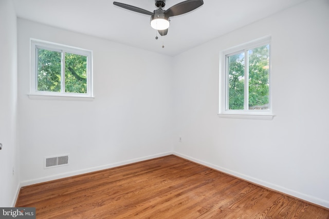 spare room with ceiling fan and hardwood / wood-style flooring