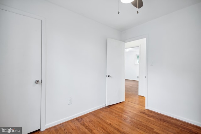 empty room featuring light wood-type flooring and ceiling fan