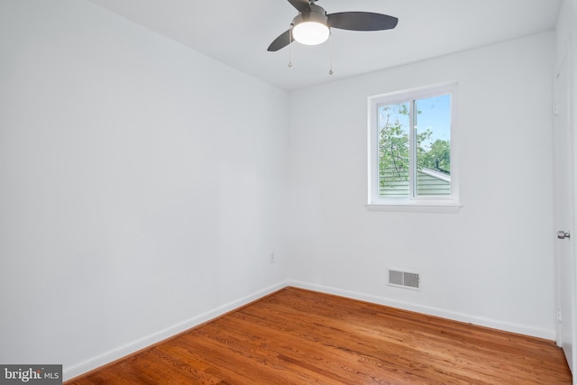 spare room with ceiling fan and hardwood / wood-style flooring