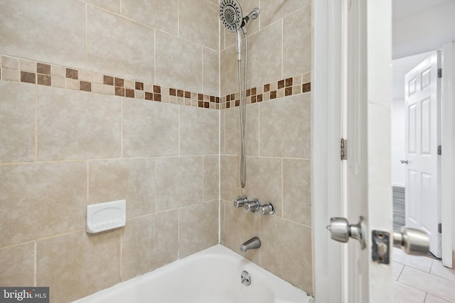 bathroom featuring tiled shower / bath and tile patterned floors