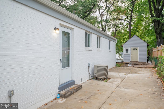 exterior space with central AC unit and a storage unit