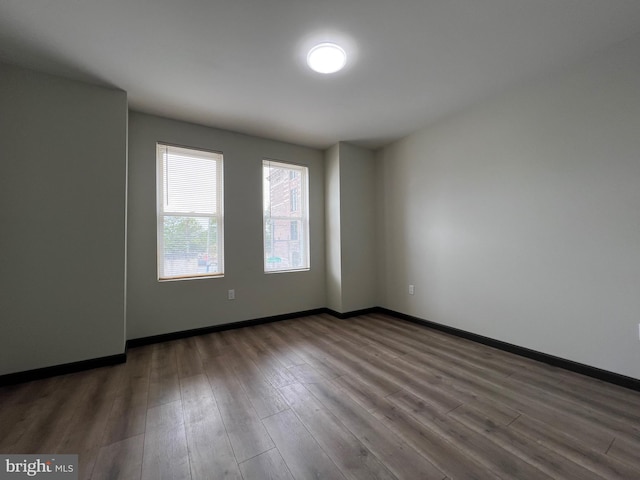 unfurnished room featuring dark hardwood / wood-style floors