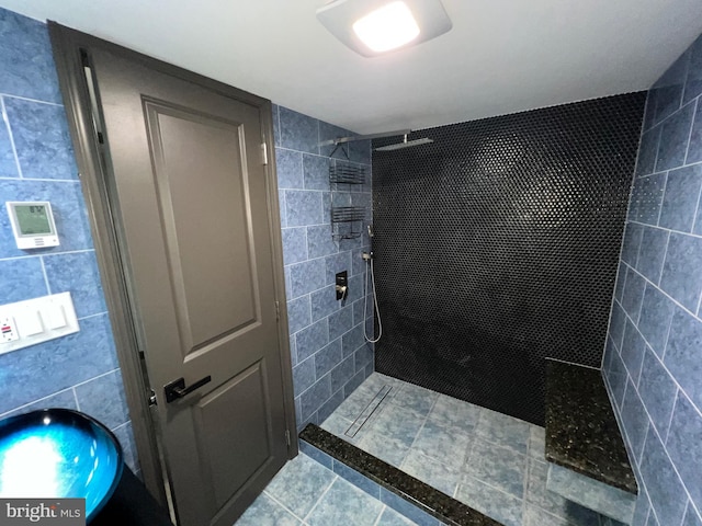 bathroom featuring tile walls, tile patterned floors, and tiled shower