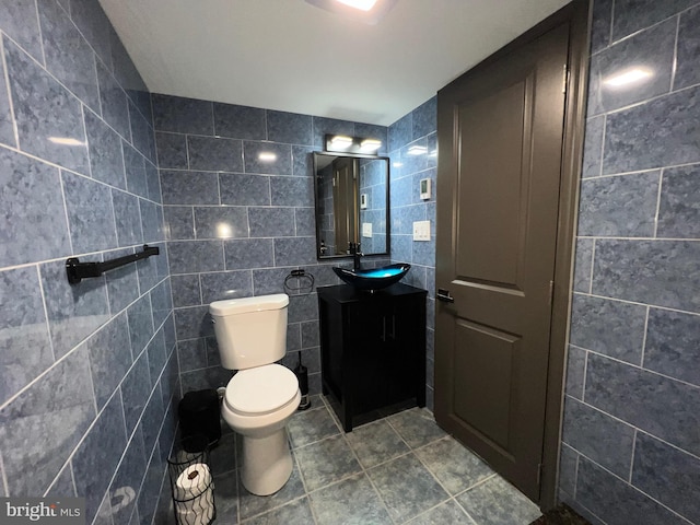 bathroom featuring tile walls, tile patterned flooring, vanity, and toilet