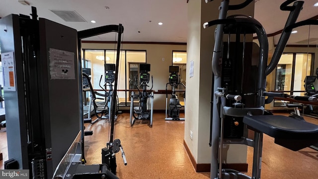 workout area featuring crown molding