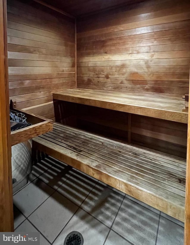 view of sauna featuring wood walls and tile patterned floors