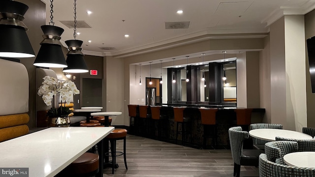 interior space with ornamental molding and wood-type flooring