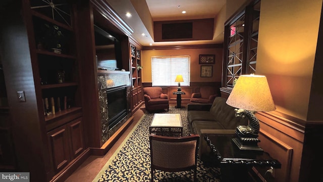 interior space with built in shelves and ornamental molding