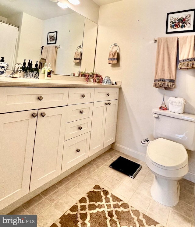 bathroom with vanity, toilet, and tile patterned floors