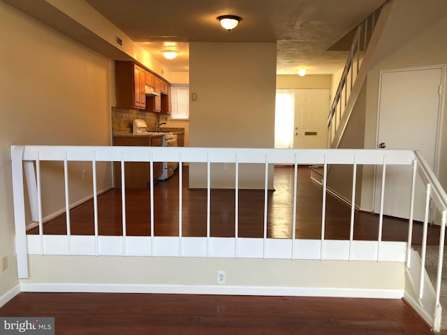 stairs featuring hardwood / wood-style floors