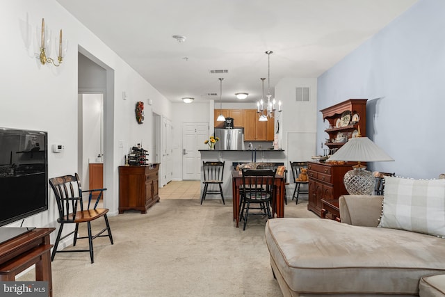 carpeted living room featuring an inviting chandelier