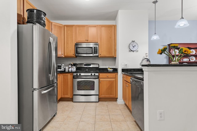 kitchen with hanging light fixtures, sink, light tile patterned floors, appliances with stainless steel finishes, and kitchen peninsula