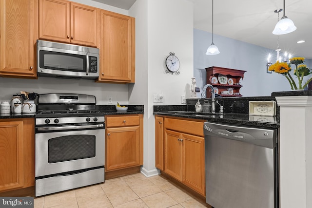 kitchen featuring light tile patterned floors, stainless steel appliances, hanging light fixtures, and sink