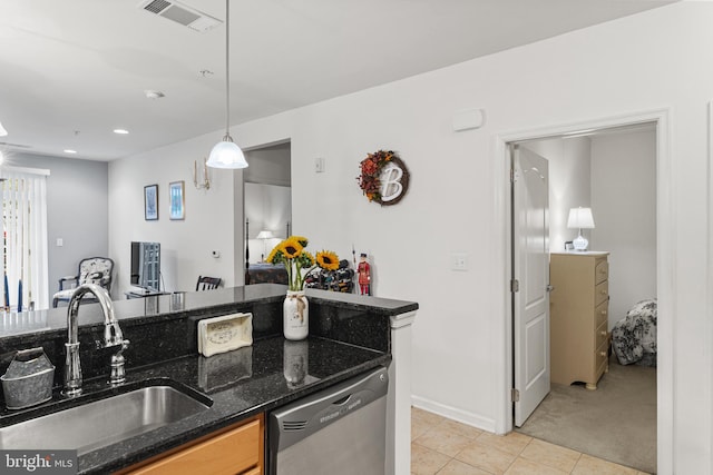 kitchen featuring light carpet, stainless steel dishwasher, dark stone counters, sink, and pendant lighting