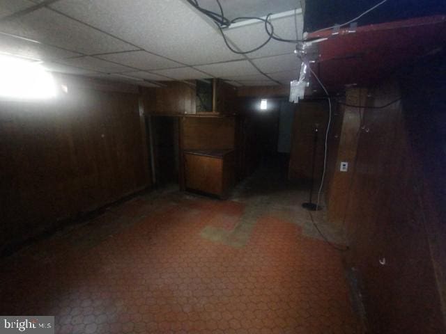 basement with a paneled ceiling