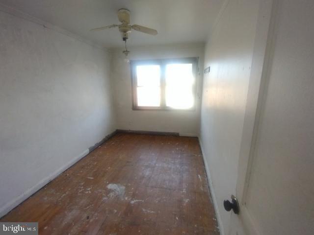 spare room featuring ceiling fan and dark hardwood / wood-style floors