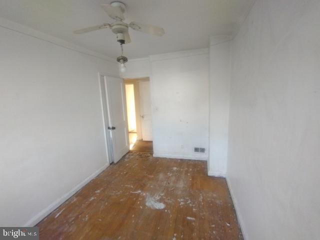 spare room with ceiling fan and hardwood / wood-style flooring