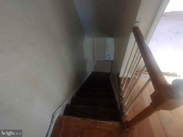 staircase with hardwood / wood-style floors