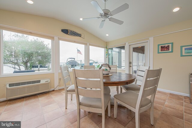 dining space with ceiling fan, light tile patterned flooring, lofted ceiling, and a wall unit AC