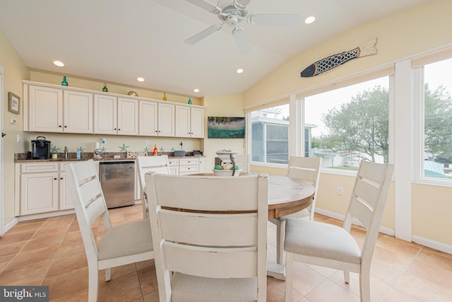 dining area featuring ceiling fan, light tile patterned floors, and vaulted ceiling