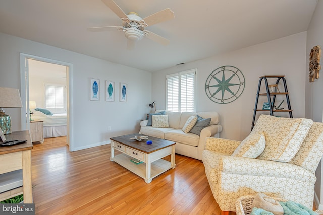 living room featuring ceiling fan and light wood-type flooring