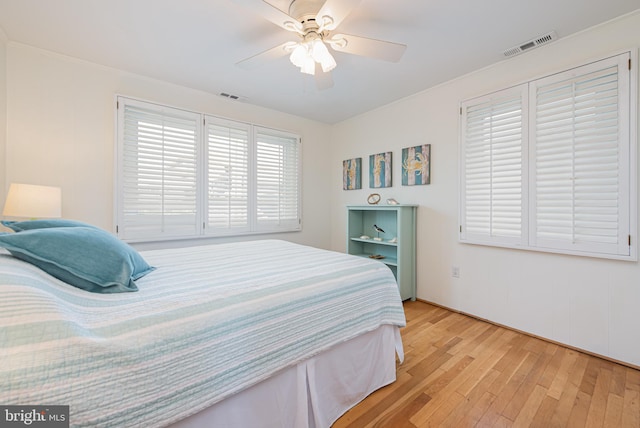 bedroom with light hardwood / wood-style flooring and ceiling fan