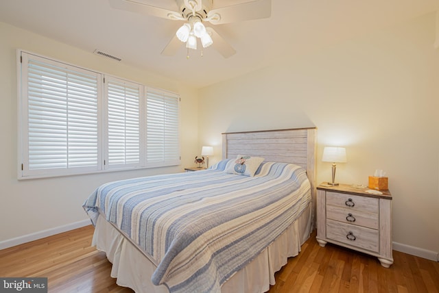 bedroom with light hardwood / wood-style flooring and ceiling fan