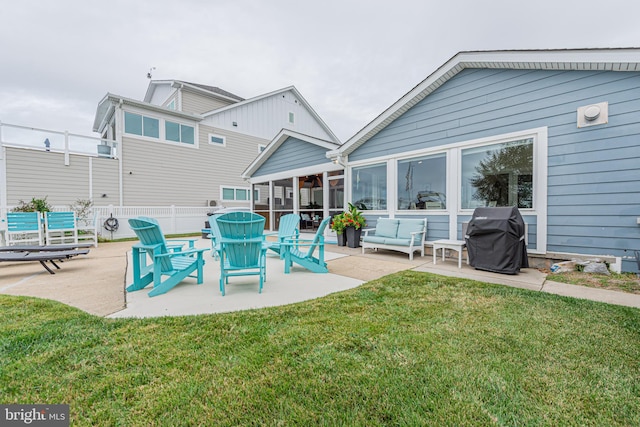 back of property featuring a sunroom, a patio area, and a yard