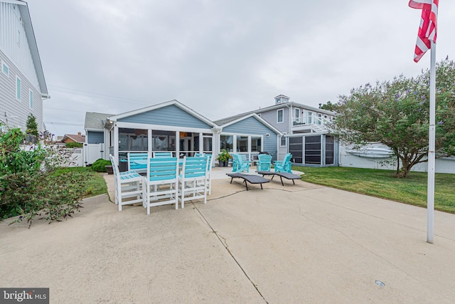 view of patio featuring a sunroom