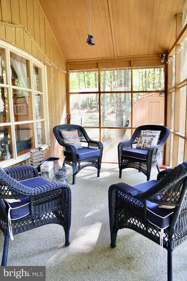 sunroom featuring vaulted ceiling and wooden ceiling