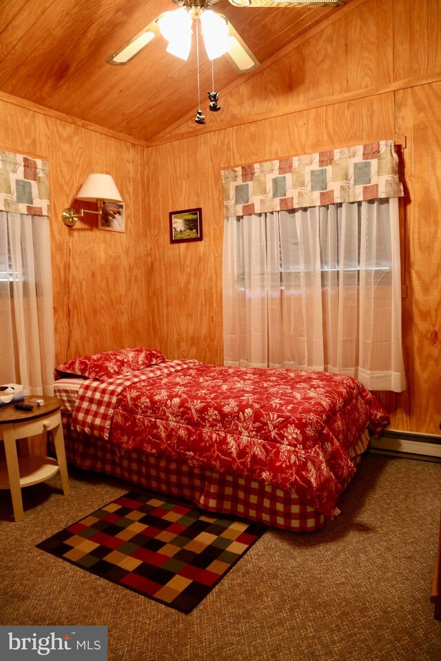 bedroom featuring lofted ceiling, ceiling fan, wood ceiling, wood walls, and carpet