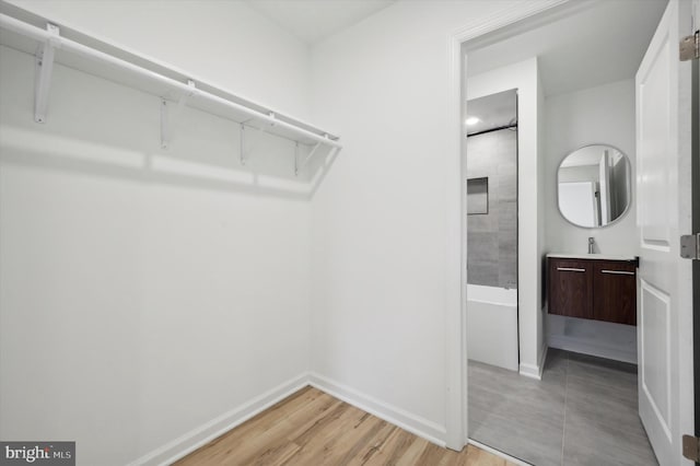 walk in closet featuring light hardwood / wood-style floors