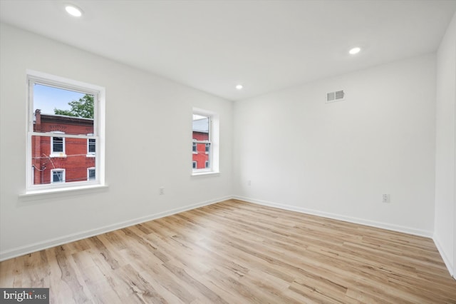 unfurnished room with light hardwood / wood-style flooring